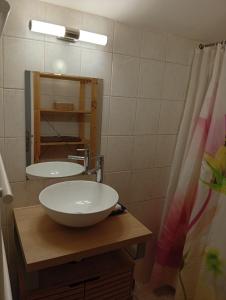 a bathroom with a sink and a mirror at Charme - Centre historique de Die in Die +20 photos