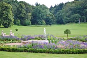 a garden with a fountain and flowers in a park at Reigate - 1 Bed by Mobius Property Solutions in Reigate +3 photos
