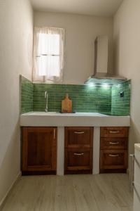 a kitchen with a sink and a window at Archontiko Seaside Hotel-Beachfront Blue Experience in Platanias +61 photos