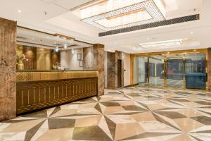 a lobby of a hotel with a checkered floor at Kzar Central in Kolkata +132 photos