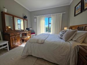a bedroom with a large bed and a window at Caledonia Guest Room in Trichardt
