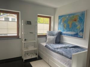 a bedroom with a bed with a map on the wall at Ferienwohnungen Tarmann in Bodensdorf