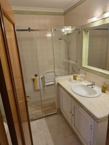 a bathroom with a sink and a shower at Sol Apartments in Vilamoura +22 photos