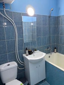a bathroom with a toilet and a sink and a tub at Danuvia Studio 2 in Drobeta-Turnu Severin +29 photos