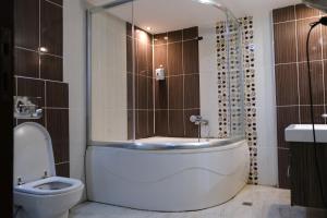 a bathroom with a toilet and a shower and a sink at TRUVA LİFE OTEl in Samandağı +22 photos