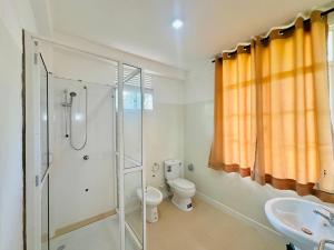 a bathroom with a shower and a toilet and a sink at La Margaritha Hotel & Banquet Hall in Udugampola