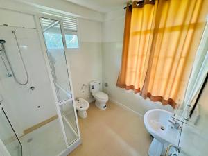 a bathroom with a shower and a toilet and a sink at La Margaritha Hotel & Banquet Hall in Udugampola