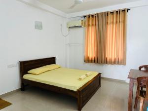 a bedroom with a bed and a window at La Margaritha Hotel & Banquet Hall in Udugampola