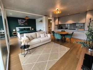 a living room with a couch and a table and a bed at Luxury Home JuNa in Aarau