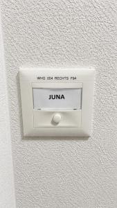 a lightswitch on a wall with a jime on it at Luxury Home JuNa in Aarau