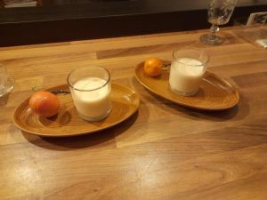 two plates with two glasses of milk on a table at Chez Is-Mi in Chauriat +2 photos