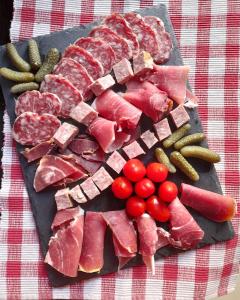 a tray of meats and vegetables on a table at Chez Is-Mi in Chauriat