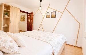 a bedroom with a bed with a white blanket at Apartmán pod Skalou in Vysoká nad Kysucou +24 photos