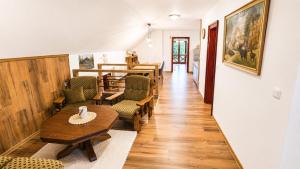 a hallway with tables and chairs and a dining room at Apartmán pod Skalou in Vysoká nad Kysucou