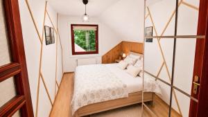 a small bedroom with a bed and a window at Apartmán pod Skalou in Vysoká nad Kysucou