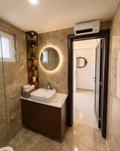 a bathroom with a sink and a mirror at Vila Dinka in Lipovac +50 photos