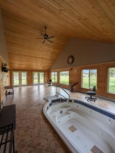 a large room with a large tub in the middle of a house at NV Mountainview Chalets & RV Resort in McBride +174 photos