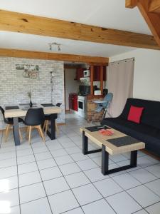 a living room with a couch and a table at La p'tite maison in Bordeaux-Saint-Clair