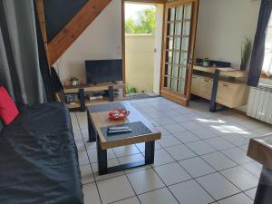 a living room with a couch and a table at La p'tite maison in Bordeaux-Saint-Clair +10 photos
