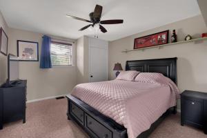 a bedroom with a bed and a ceiling fan at Derby Dreams llc in Clarksville