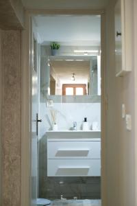 a bathroom with a white sink and a mirror at Evi's House in Kandia +32 photos
