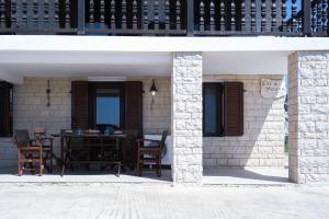 a patio with a table and chairs on a house at Evi's House in Kandia