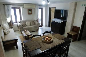 a living room with a table and a tv at Evi's House in Kandia