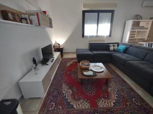 a living room with a couch and a table at Agli Ulivi in Filo