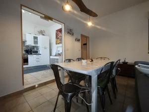 a dining room with a table and chairs and a kitchen at Agli Ulivi in Filo