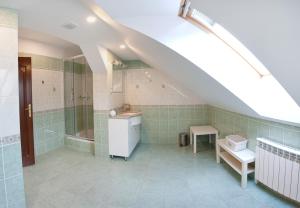 an attic bathroom with a shower and a sink at Mazurska Tajemnica 1 in Łoje +23 photos