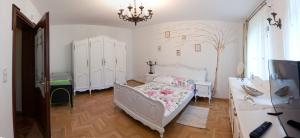 a bedroom with a bed and a chandelier at Mazurska Tajemnica 1 in Łoje