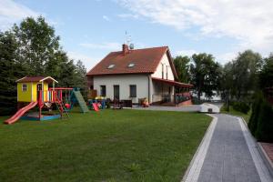 a house with a yard with a playground at Mazurska Tajemnica 1 in Łoje