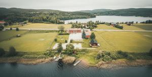 an aerial view of a house on an island in the water at Tängerdalens camping och café in Övertänger