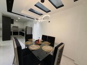 a dining room with a black table and chairs at DLiam Home in Baños