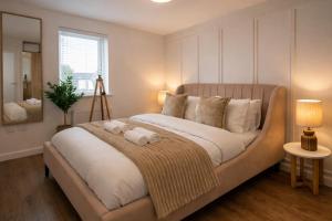 a bedroom with a large bed with two towels on it at LushMint&Sound in Bristol