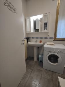 a bathroom with a washing machine and a sink at Agli Ulivi in Filo +26 photos