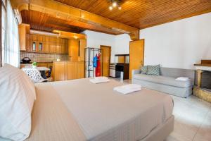 a bedroom with a large bed and a kitchen at Lena Apartments 4 in Potos