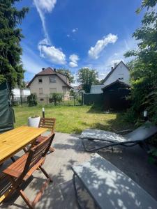 a picnic table and chairs on a patio at Cozy house with garden in Mulhouse