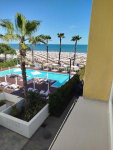 a view of a swimming pool and the beach at Hotel Silva Frontemare PARK & BEACH-PLACE INCLUDED in Lido di Jesolo