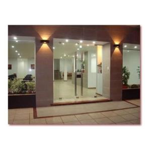 a lobby of a building with windows and lights at Gran Continente Santa Teresita in Santa Teresita