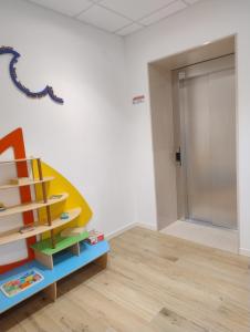 a room with a toy staircase and a door at Albergo Medusa in Punta Marina