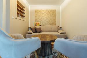 a living room with a couch and a table at Boutique Apartments Daniela in Faak am See