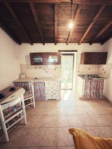 a large kitchen with wooden ceilings and a large window at alloggio turistico Castel di Salce in Viterbo