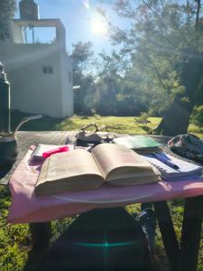 an open book sitting on top of a picnic table at La casita de Gorrión in Villa Ventana