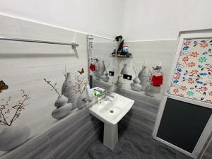 a bathroom with a sink and vases on the wall at Ever Green Mount in Ella +133 photos