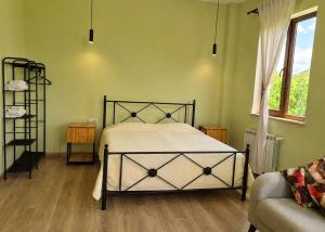 a bedroom with a bed and a couch and a window at Canyon View Dsegh in Dsegh +30 photos