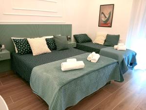 a room with two beds and a couch at Umbrella Street Home in Catania
