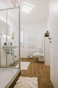 a bathroom with a tub and a sink and a toilet at Waldblick am Ring in Kelberg +42 photos