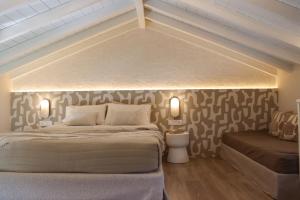 a bedroom with a bed and a couch in a room at Vabel Skiathos in Skiathos