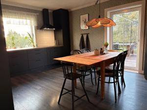 a kitchen with a wooden table and chairs at Hus Orsa in Orsa